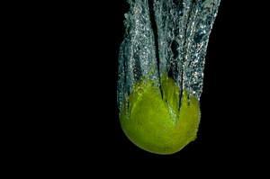 Lemon dropped in water: A lemon dropped in water with a black background