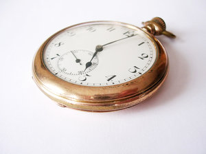 Pocket Watch 2: My great-grandfather's pocket watch. Different angles and different times shown. A side note: I had trouble getting a photo without my camera and fingers being reflected on the gold rim of the watch. If there's a better way to do this please let me know!