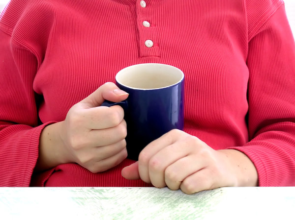 Mug of tea: A mum-to-be relaxing with a mug of tea.