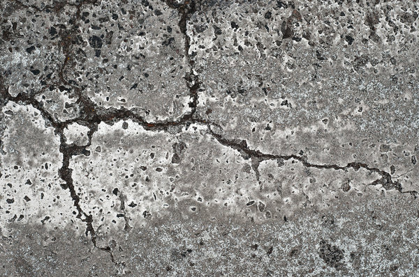Cracked Pavement: Broken or cracked pavement at a crosswalk in Denver, Colorado.