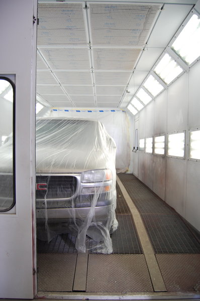 Time to paint!: A truck ready to be painted in a professional paint booth.
