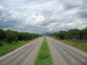 empty highway: an empty highway, leading to a city in the distance.  35W north into minneapolis was closed for construction work at the diamond lake bridge.
