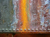 Old locomotive plate: Rusted metal sheet with a single-row riveted joint. Different textures in the series.