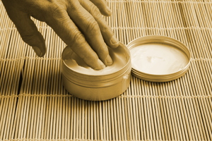 Skin care: Taking skin cream from a pot