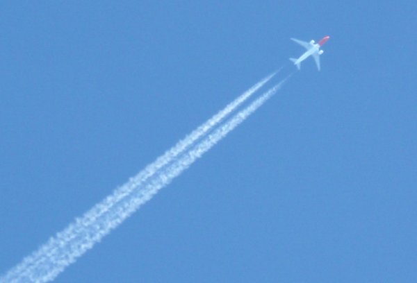 Airplane in the sky: Airplane with contrails
