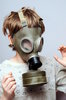 Boy in the soviet gas mask  5: Mask worn over the face to protect the wearer from inhaling airborne pollutants and toxic materials