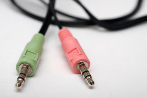 TRS connectors of computers he: Audio connectors - cylindrical in shape, typically with three contacts, although sometimes with two (a TS connector) or four (a TRRS connector). One plug is for headphones and second for microphone.