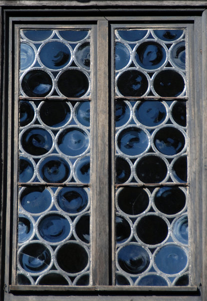 Medieval window: Window with roud glasses  in medieval castle Burg Falkenstein, Germany