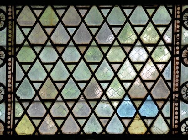 Medieval stained-glass texture: View trough medieval window with diamond form glasses
