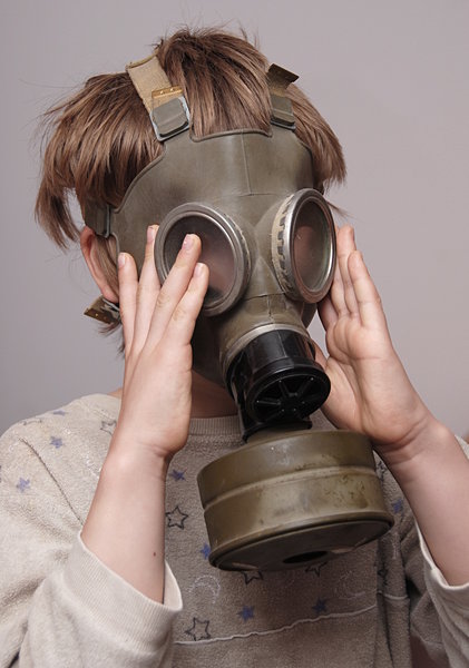 Boy in the soviet gas mask  3: Mask worn over the face to protect the wearer from inhaling airborne pollutants and toxic materials