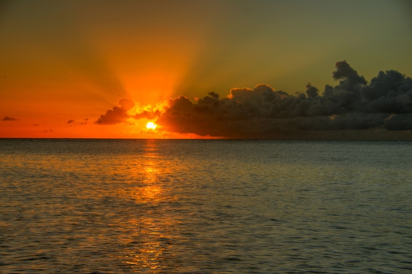 Sunrise - HDR: Sunrise above the ocean with lots of sunrays. The image is HDR,