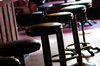 Stools.: Several stools in a pub.