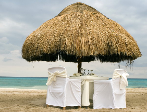 romantic summer beach: dinner tables on the sunny beach