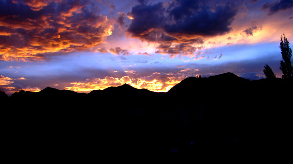 Crimson Skies: The setting sun paints the sky. Leh Town.