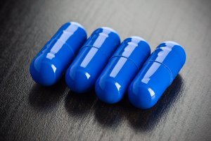 Medication: Some blue mediction on a black surface