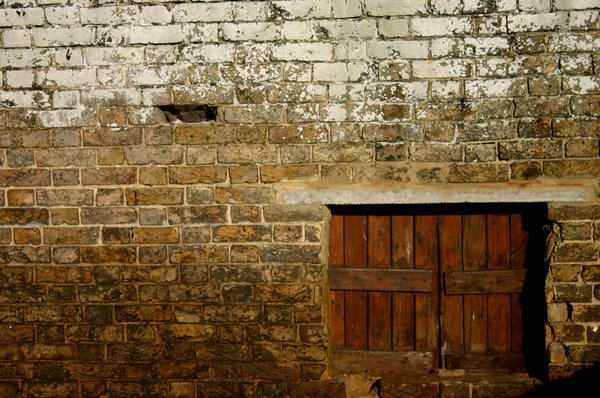 Peek A Boo: An old wooden hatch in a very odd placed, positioned in the centre of a grimy stone brick wall.