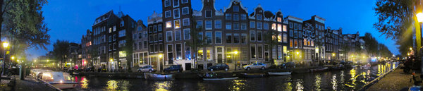 Amsterdam panorama: View of Amsterdam canal with traditional houses at night