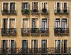 Windows and balconies: Windows and balconies of a large tenement in Italy.