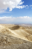 Israel desert: View from Mount Azazel in the Judean desert, Israel. There are six or seven cyclists on the mid-distance track.