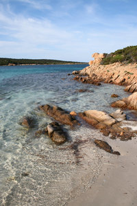 Quiet cove: Clear aquamarine seawater in a quiet cove in Sardinia.