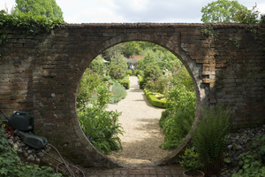 Garden circle: An ocular brick wall feature in a garden in Hampshire, England.