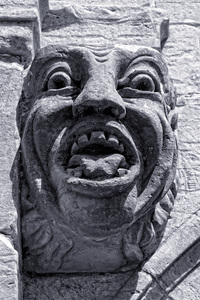 Surprised gargoyle: A gargoyle on an old summerhouse in Nymans, West Sussex, England. Photography in the grounds of this National Trust property is freely permitted.