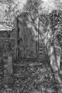 Doorway to nowhere: B/W image of the doorway to an old ruined chapel.