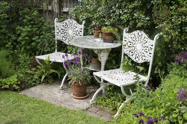 Garden table and chairs: A table and chairs in a cottage garden in West Sussex, England.