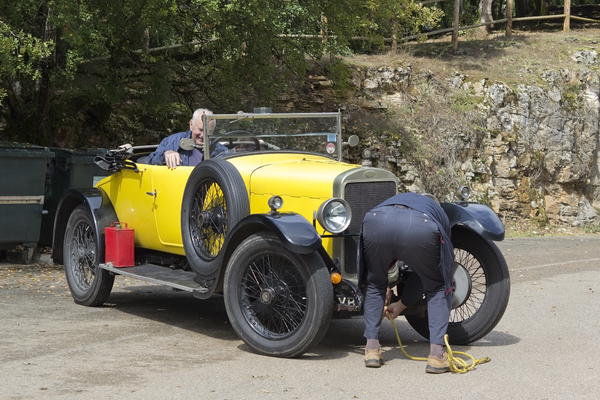 Car breakdown: Drivers of a vintage car experiencing a breakdown whilst touring in France.