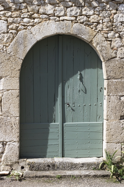 Ancient doors: An ancient pair of doors in a village in the Lot/Dordogne area of France.