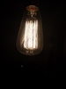 old light bulb: Low intensity old light bulb in dark background