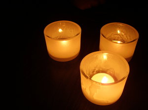 Candles in dark: Close ups of candles in glasses at night