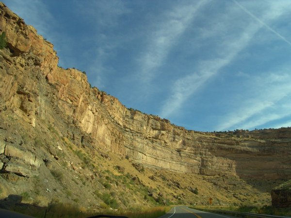 Highway to Grand Mesa,Colorado: High cliff walls aline the highway to Grand Mesa, Colorado and is a stricking road trip with blue sky above.