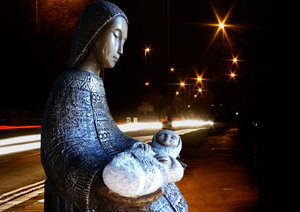 Nativity in the city: Nativity - mother and child - with star light glowing from street lights