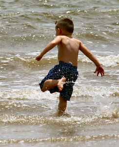 Kicking Feet: Boy playing in the bay