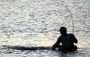 Morning Fisherman: A man fishing at sunrise on Galveston Bay