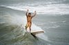 Yelling for joy: Surfers intentional back flip after completing a tube. He shouted for joy