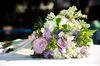 Bridal Bouquet: Lavender and white bridal bouquet on wedding reception table