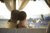 Facing out.: The newlyweds on a Cabana chair.