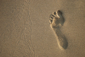 Imprints: Imprints by foot and waves.