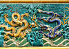 dragon wall: dragon decorated wall alongside public footpath
