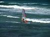 wind surfer: wind surfer trying to maintain balance while sail is pushed by the wind
