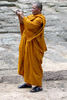 saffron snapper: Buddhist monk snapping photos at Angkor Wat, Cambodia