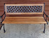 cottage bench seat: wrought iron & wood bench seat outside pioneer cottage