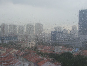 rainy day scene: looking down on roofs of street below through rain spattered window
