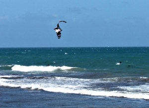 surf gliding - kite surfing: pulled along by the wind in the sails while surf gliding - kite surfing