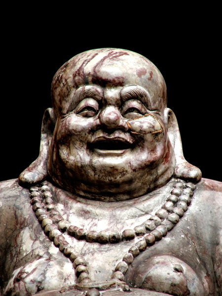 chubby Buddha: cracked and poorly repaired temple Buddha statue