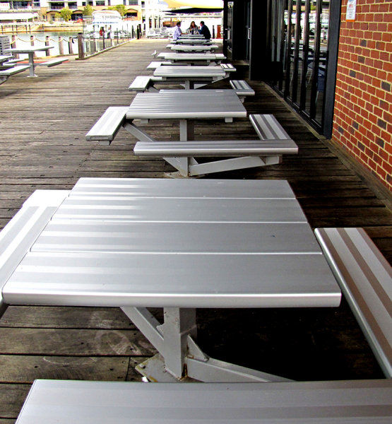 waiting for a meal: aluminium alfresco dining settings at marina
