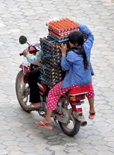 egg-spress delivery: balancing act delivering fresh eggs to hotel in Cambodia