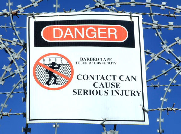 sharp warning: sign warning of the danger of razor wire